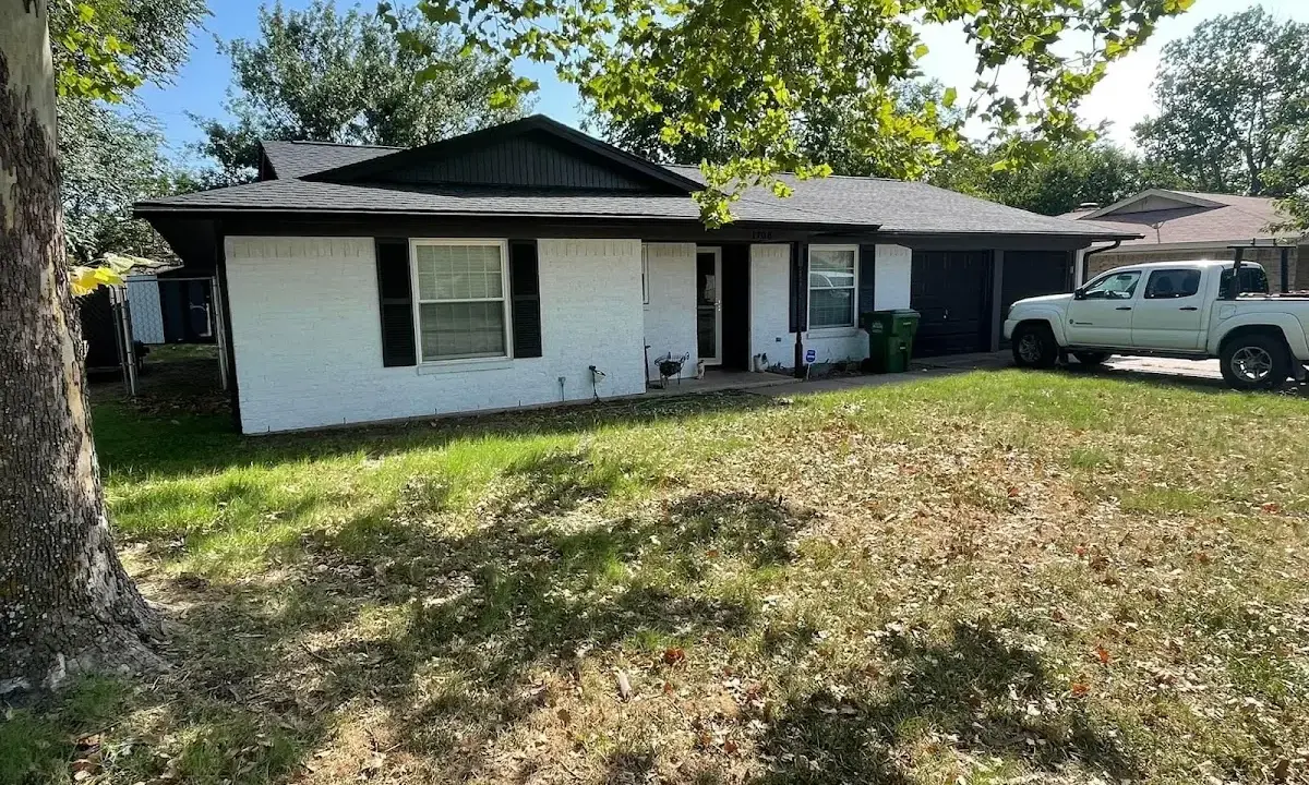 Professional roofing crew working on a residential roof in East Hills